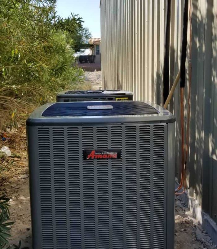 Air conditioning unit on side of garage