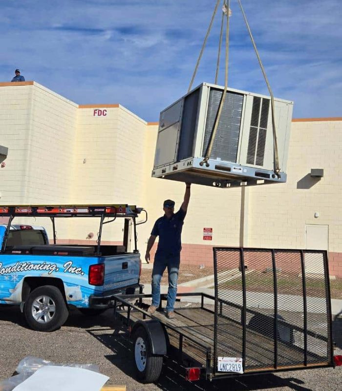 Commercial air conditioner being lifted by a crane