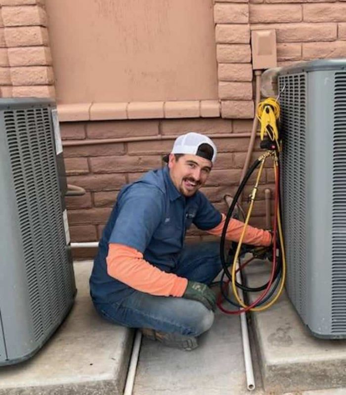 HVAC technician adjusting cables on ac unit